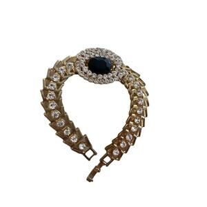 Beautiful gold tone bracelet with rhinestones and a large black gem